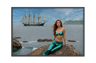 sexy mermaid on rock with ship in background